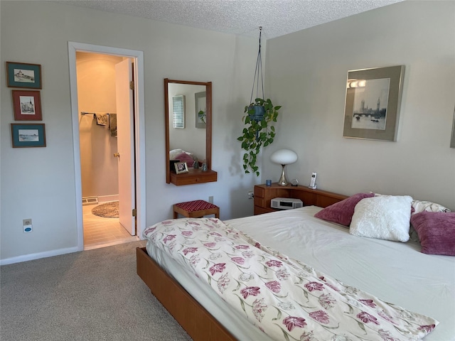 bedroom featuring baseboards, a textured ceiling, and carpet flooring