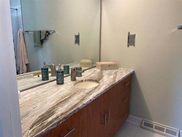 bathroom with tile patterned floors, visible vents, baseboards, and vanity