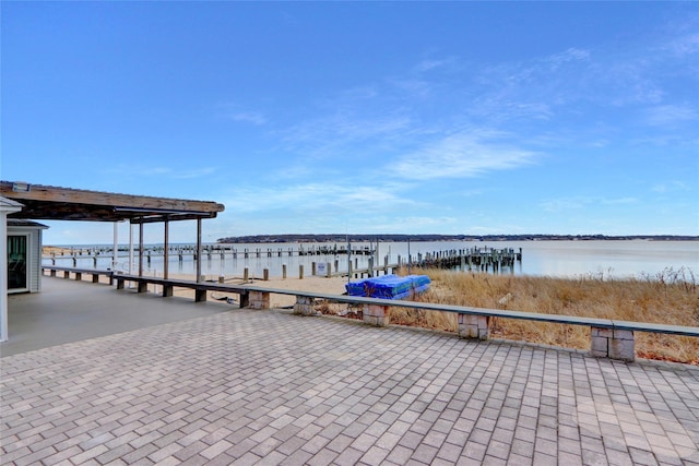 dock area with a water view and boat lift