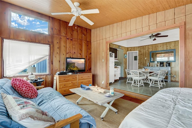 living room featuring wooden walls, wood ceiling, ceiling fan, and wood finished floors