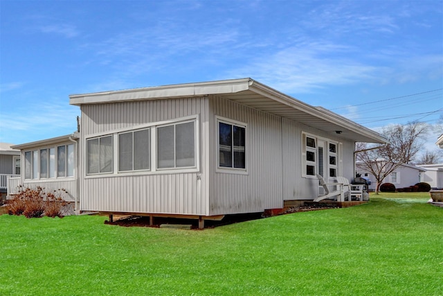 view of home's exterior with a yard