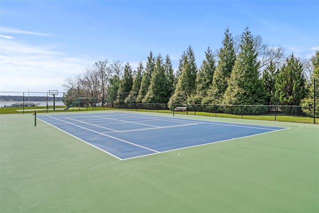 view of sport court with playground community and fence