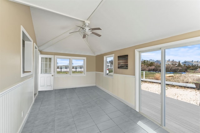 unfurnished sunroom with lofted ceiling, a healthy amount of sunlight, and a ceiling fan