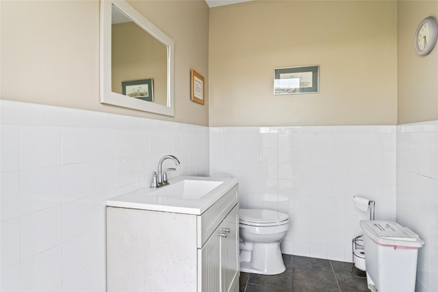 bathroom with vanity, tile walls, toilet, and tile patterned floors