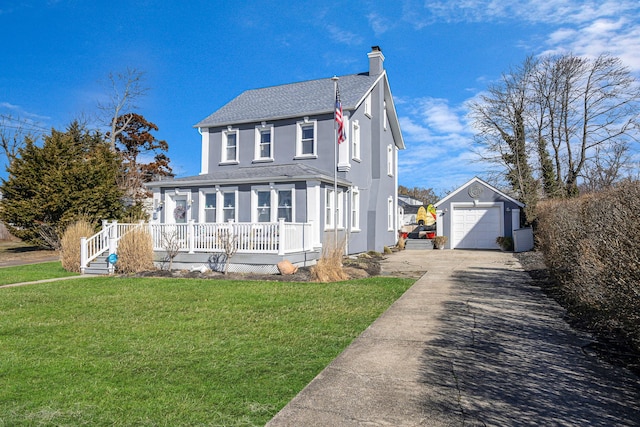 view of front of property with an outbuilding, a porch, concrete driveway, a front lawn, and a detached garage