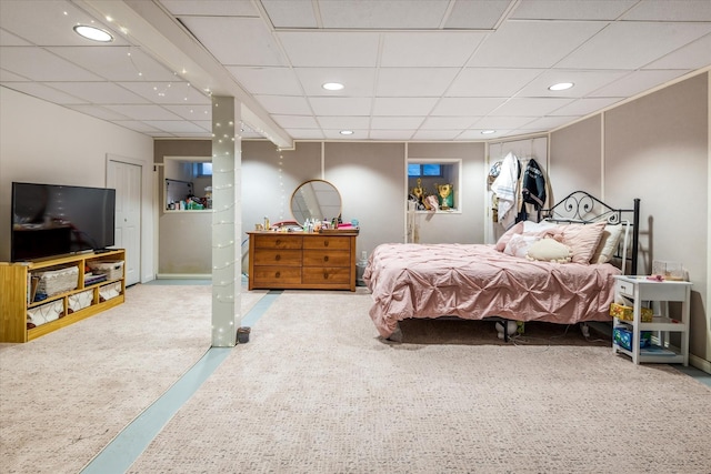 carpeted bedroom with recessed lighting and a drop ceiling