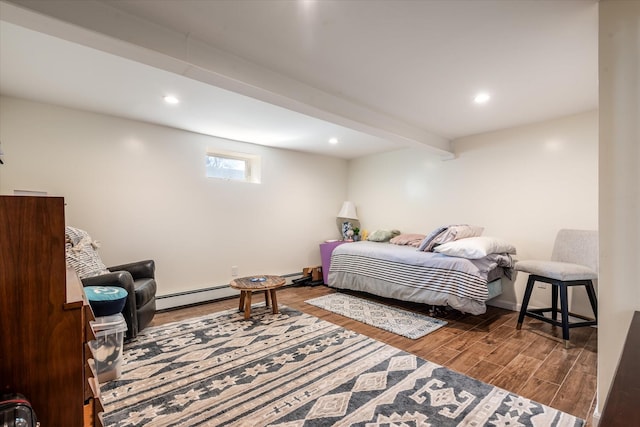 bedroom featuring beam ceiling, recessed lighting, wood finished floors, and a baseboard radiator