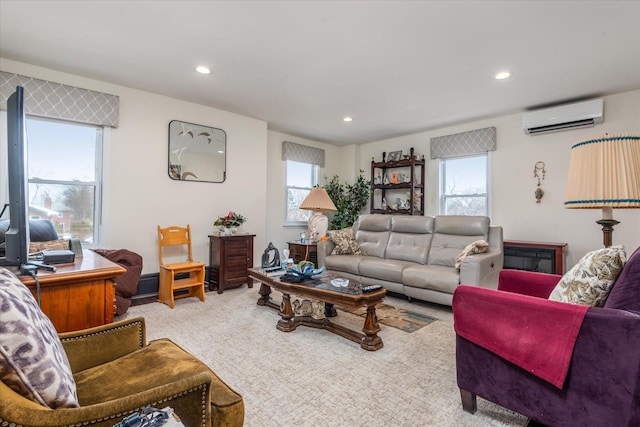 living area with a wall mounted air conditioner, carpet, and recessed lighting