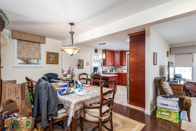 dining area featuring a healthy amount of sunlight and dark wood finished floors