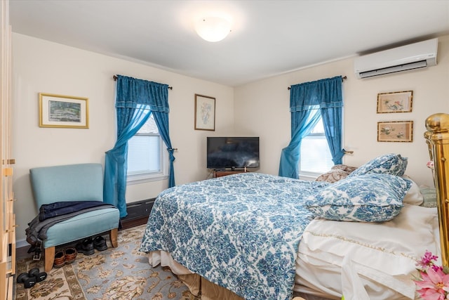 bedroom with a wall unit AC and multiple windows