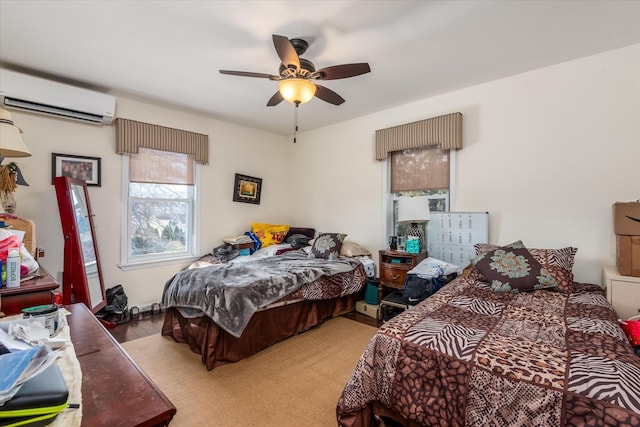 bedroom with ceiling fan and a wall mounted AC