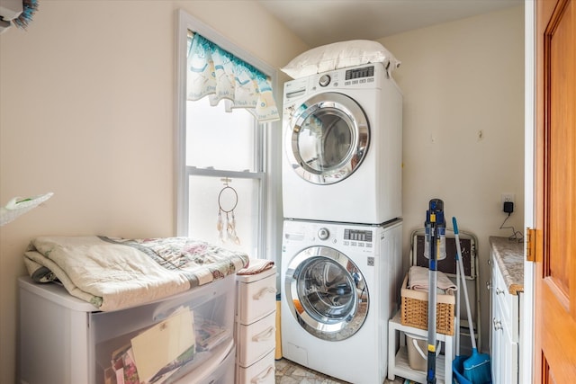 laundry room with laundry area and stacked washer / dryer