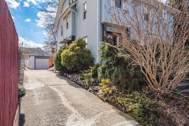 view of home's exterior featuring a detached garage and an outdoor structure