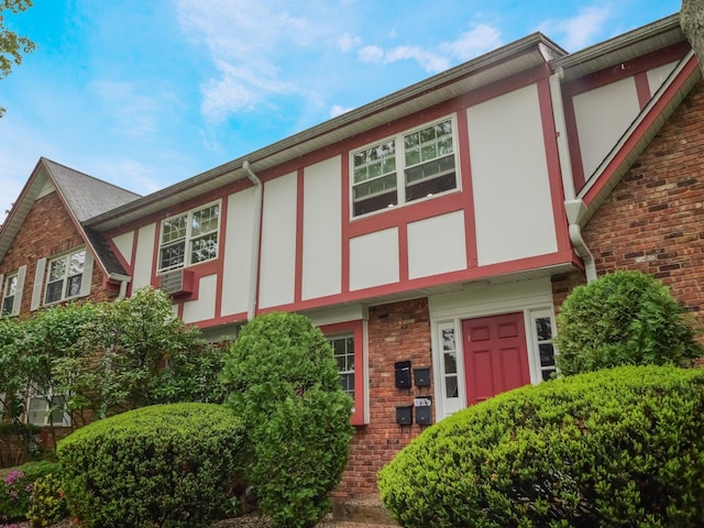 view of front of house featuring stucco siding and brick siding
