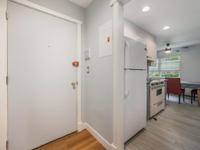 kitchen with white appliances, light wood-type flooring, white cabinets, a ceiling fan, and recessed lighting