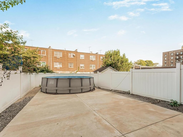 view of patio with a fenced in pool and a fenced backyard