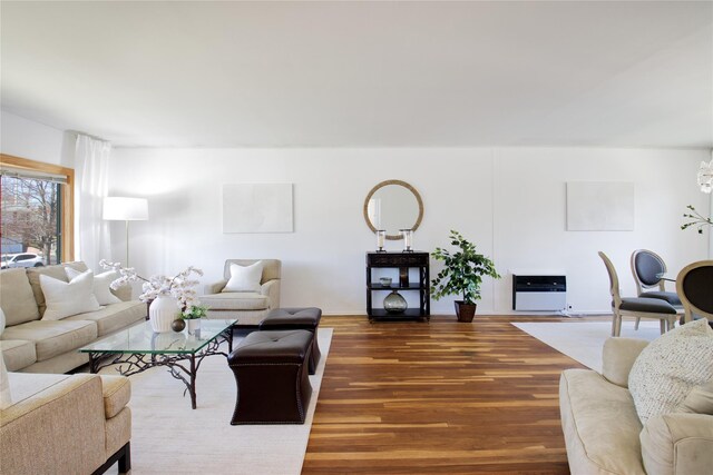 living area featuring heating unit and wood finished floors