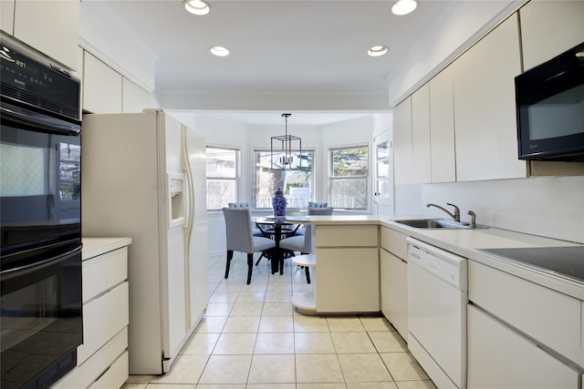 kitchen with a sink, black appliances, crown molding, and light tile patterned floors