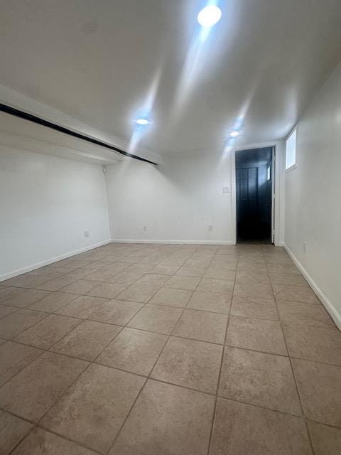 empty room featuring tile patterned floors and baseboards