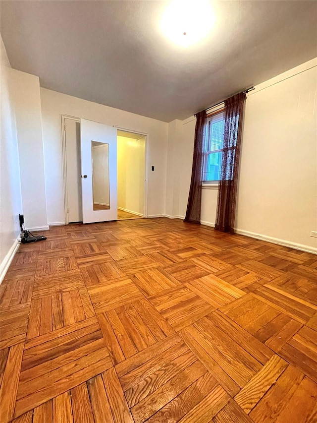 empty room featuring baseboards