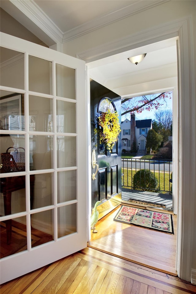 doorway featuring french doors, crown molding, and hardwood / wood-style flooring