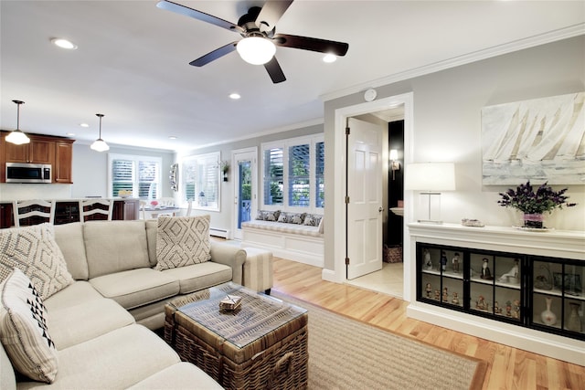 living room with crown molding, recessed lighting, light wood-type flooring, and baseboard heating