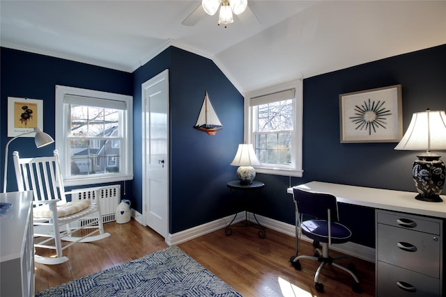 office space featuring baseboards, lofted ceiling, wood finished floors, and radiator heating unit