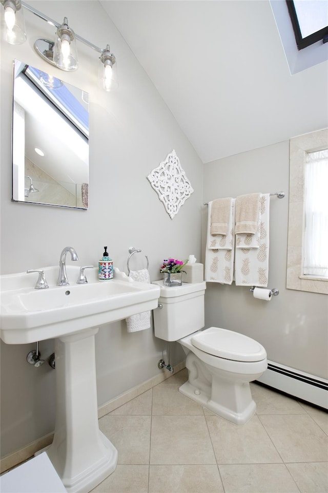 bathroom featuring tile patterned flooring, baseboard heating, toilet, and lofted ceiling