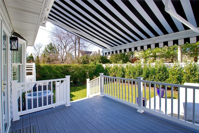 wooden terrace featuring a lawn