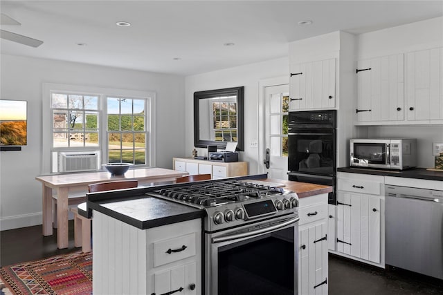 kitchen featuring dark countertops, plenty of natural light, and appliances with stainless steel finishes