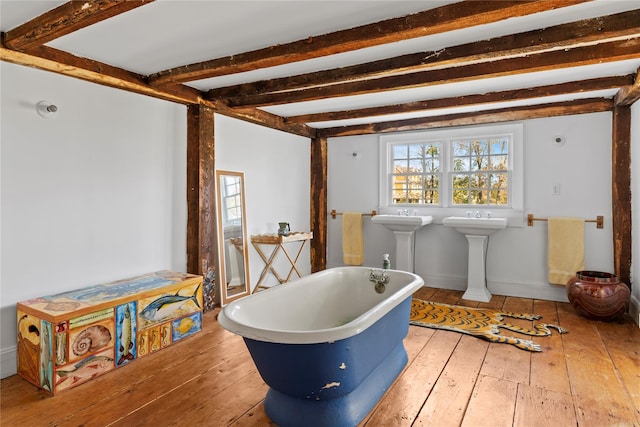 miscellaneous room featuring beam ceiling, a sink, baseboards, and hardwood / wood-style floors