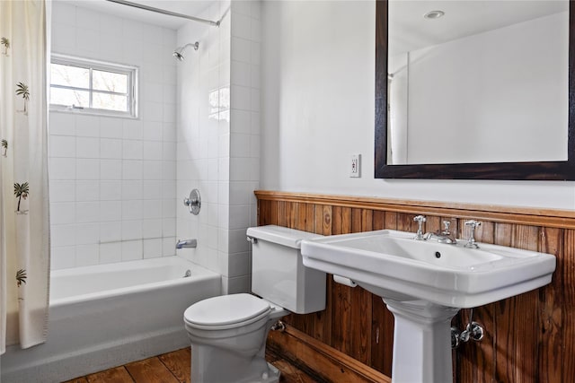 full bathroom with a sink, toilet, and shower / tub combo