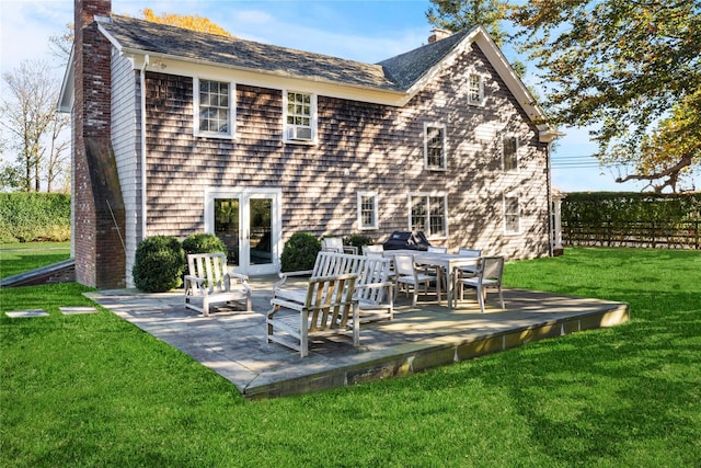 rear view of house featuring fence, a yard, cooling unit, a chimney, and a patio area