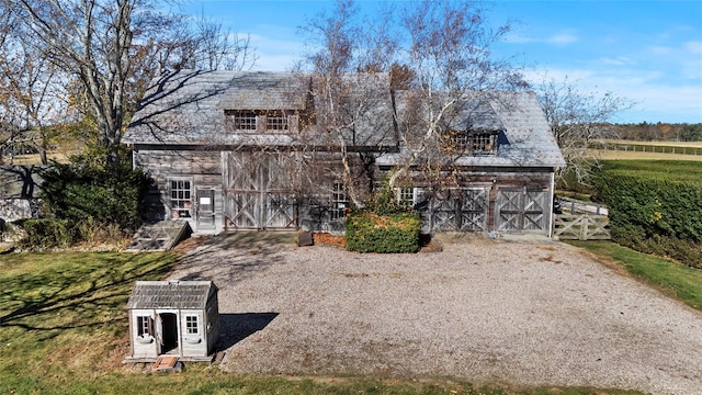 view of front of home with an outbuilding, a barn, and a front lawn