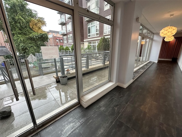 doorway to outside with baseboards