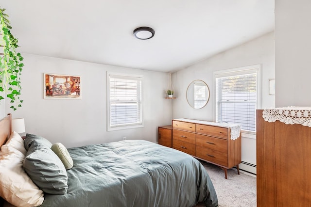 bedroom featuring vaulted ceiling, multiple windows, a baseboard radiator, and light carpet