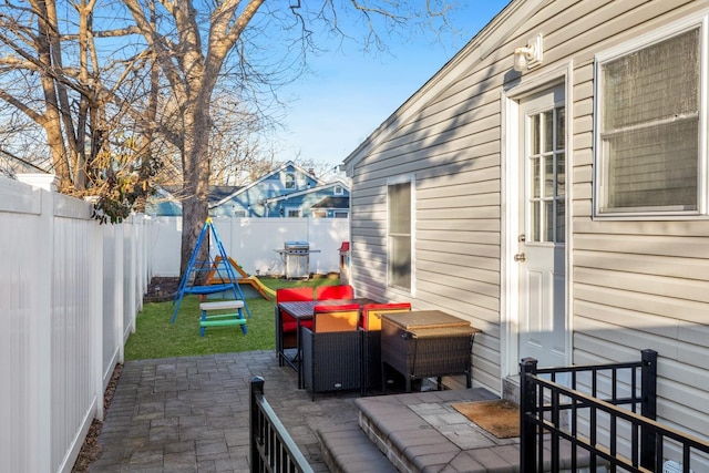 view of patio / terrace with an outdoor living space, area for grilling, and a fenced backyard