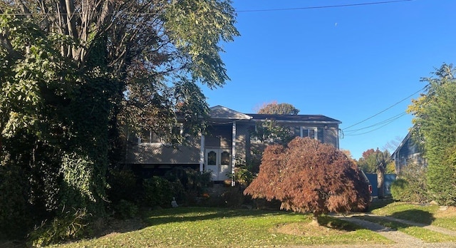 view of side of home featuring a lawn