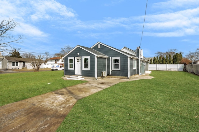 view of front of property featuring entry steps, a chimney, a front lawn, and fence