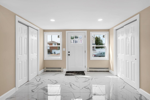 entrance foyer with baseboards, marble finish floor, and a baseboard radiator