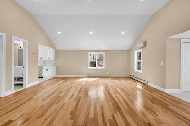 unfurnished living room featuring baseboards, light wood finished floors, high vaulted ceiling, and a wall mounted AC