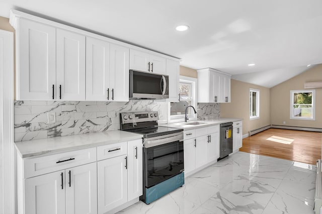 kitchen featuring a sink, stainless steel appliances, marble finish floor, and a wealth of natural light