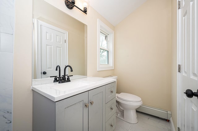 bathroom with vanity, vaulted ceiling, toilet, marble finish floor, and baseboard heating