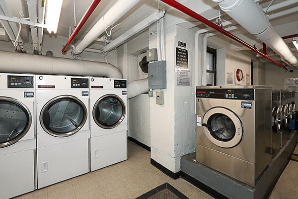 common laundry area featuring tile patterned floors, independent washer and dryer, and electric panel