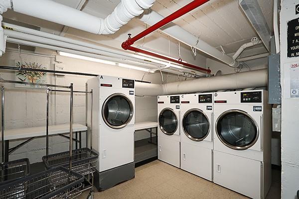 shared laundry area with washing machine and dryer and light floors