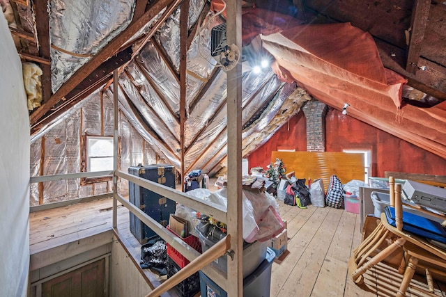 unfinished attic featuring an upstairs landing