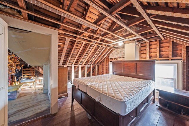 bedroom with lofted ceiling and dark wood finished floors