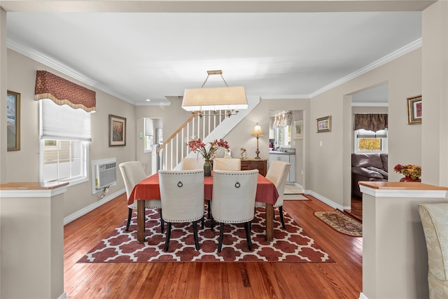 724 Thrush Ave, West Hempstead, NY 11552 - dining space featuring plenty of natural light, wood finished floors, stairs, ornamental molding, and baseboards