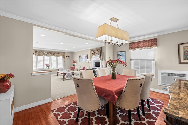 724 Thrush Ave, West Hempstead, NY 11552 - dining room with crown molding, baseboards, a chandelier, light wood-style floors, and a wall mounted AC