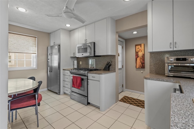 724 Thrush Ave, West Hempstead, NY 11552 - kitchen featuring stainless steel appliances, decorative backsplash, ceiling fan, white cabinetry, and recessed lighting
